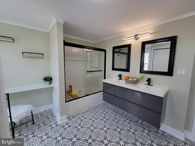 a bathroom with a tub sink and mirror