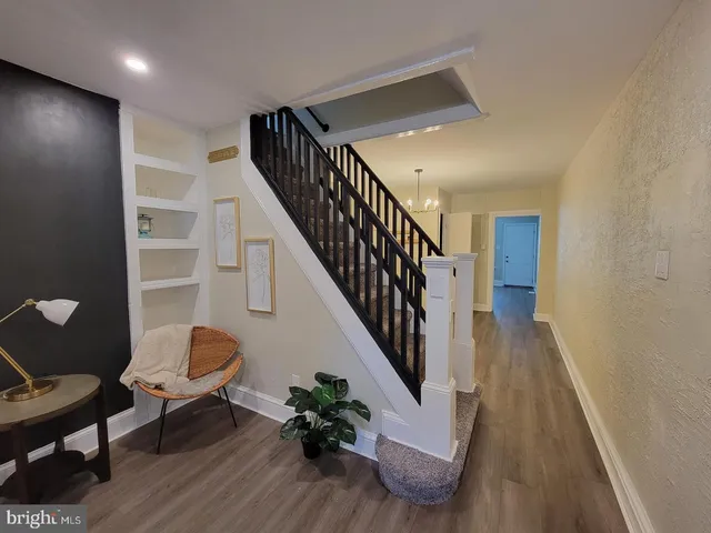 a view of entryway and hall with wooden floor