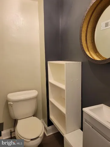 a white toilet sitting next to a shower