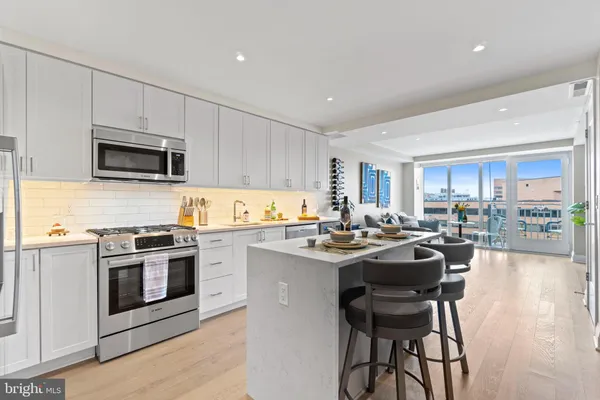 a kitchen with a stove a sink and a microwave