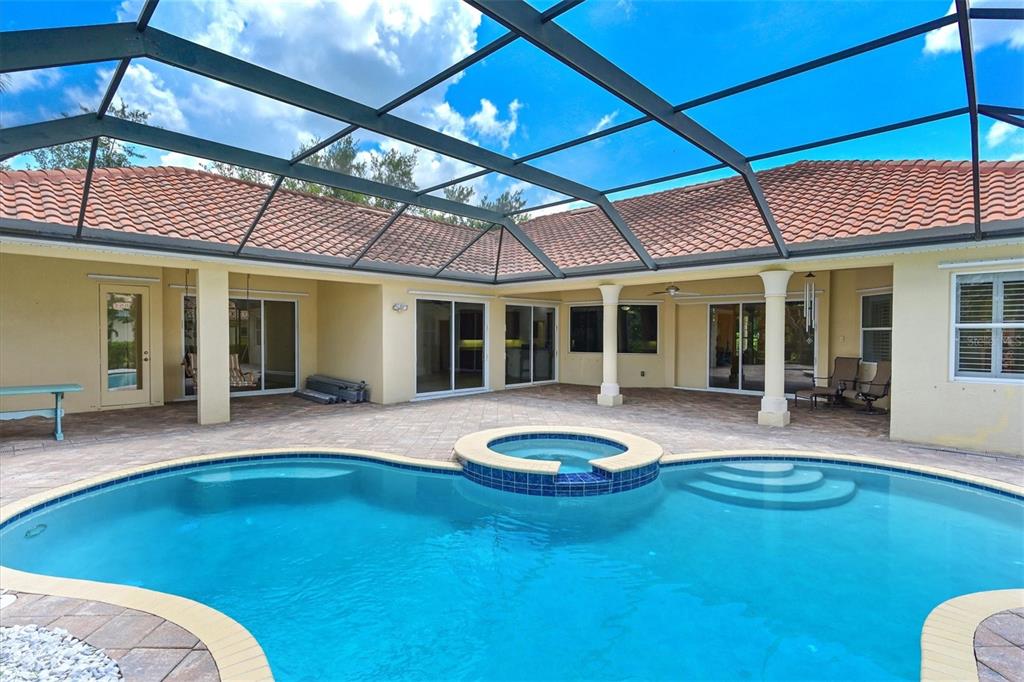 10622 Conch Shell Terrace Bradenton, FL 34212 - Photo 4 of 69 a swimming pool with patio outdoor seating and yard