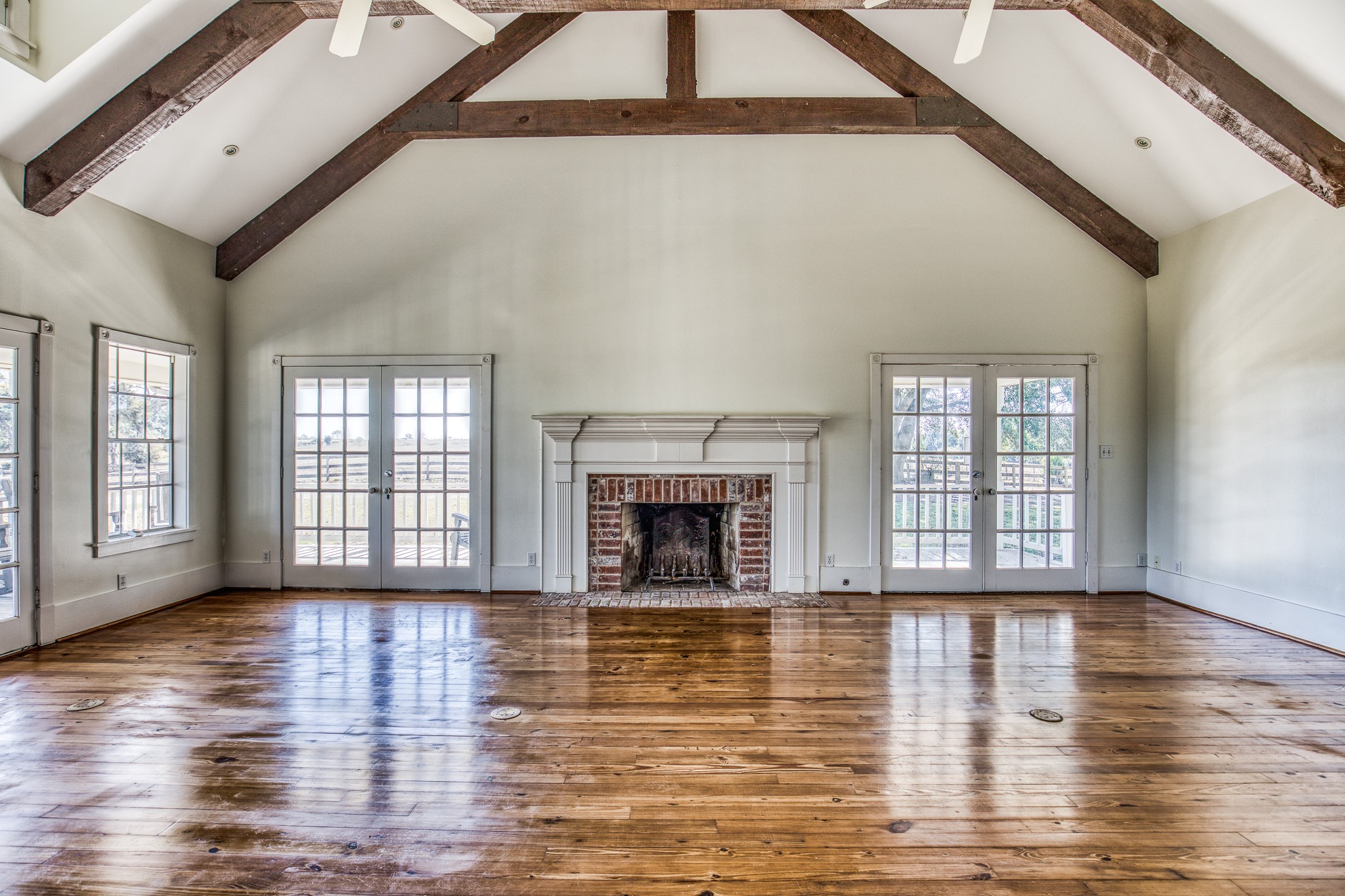 1712 Lynn Road Chappell Hill, TX 77426 - Photo 9 of 44 a view of an empty room with glass door and wooden floor