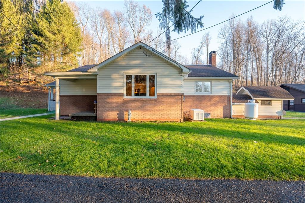 185 Foster Road Saltsburg, PA 15681 - Photo 34 of 42 a front view of a house with a yard and garage