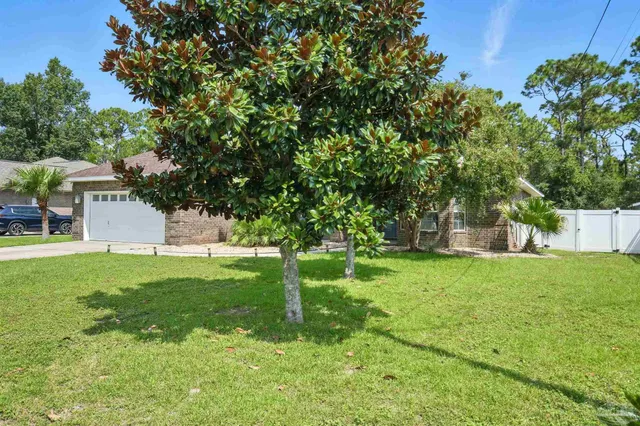 an empty room with wooden floor fireplace and windows