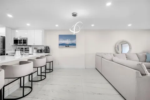 a kitchen with furniture a sink and a refrigerator