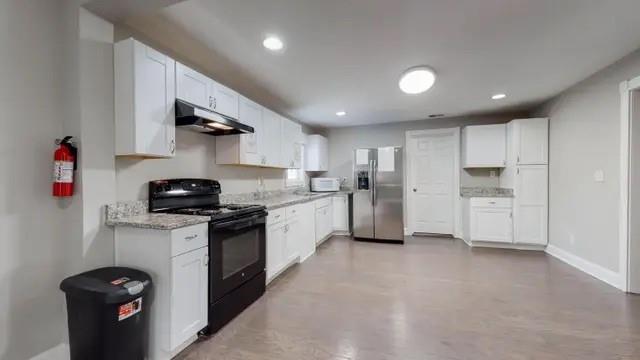 2164 Bouldercrest Road Atlanta, GA 30316 - Photo 4 of 11 a kitchen with stainless steel appliances kitchen island granite countertop a refrigerator and a sink