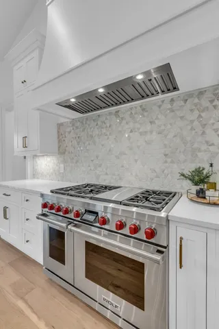 a bathroom with a sink a light fixture and a mirror