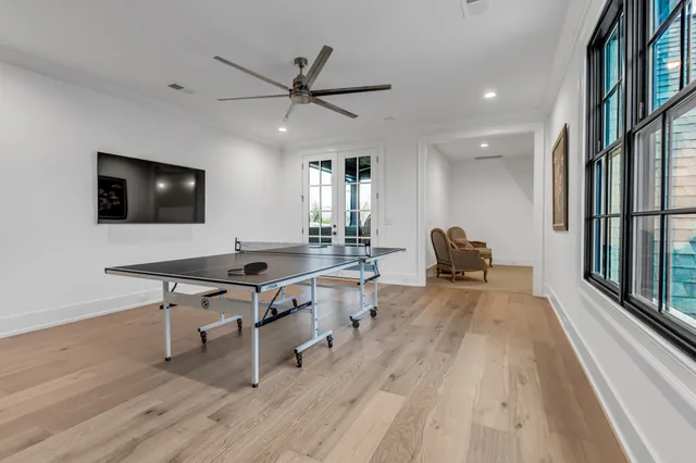 a view of a dining room with furniture large windows and wooden floor