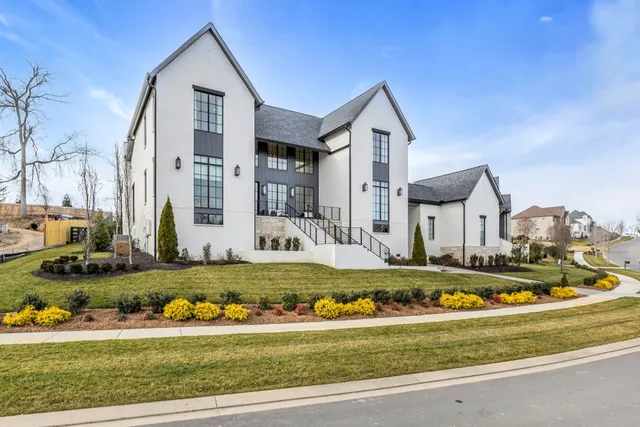 a living room with couches a flat screen tv and a fireplace