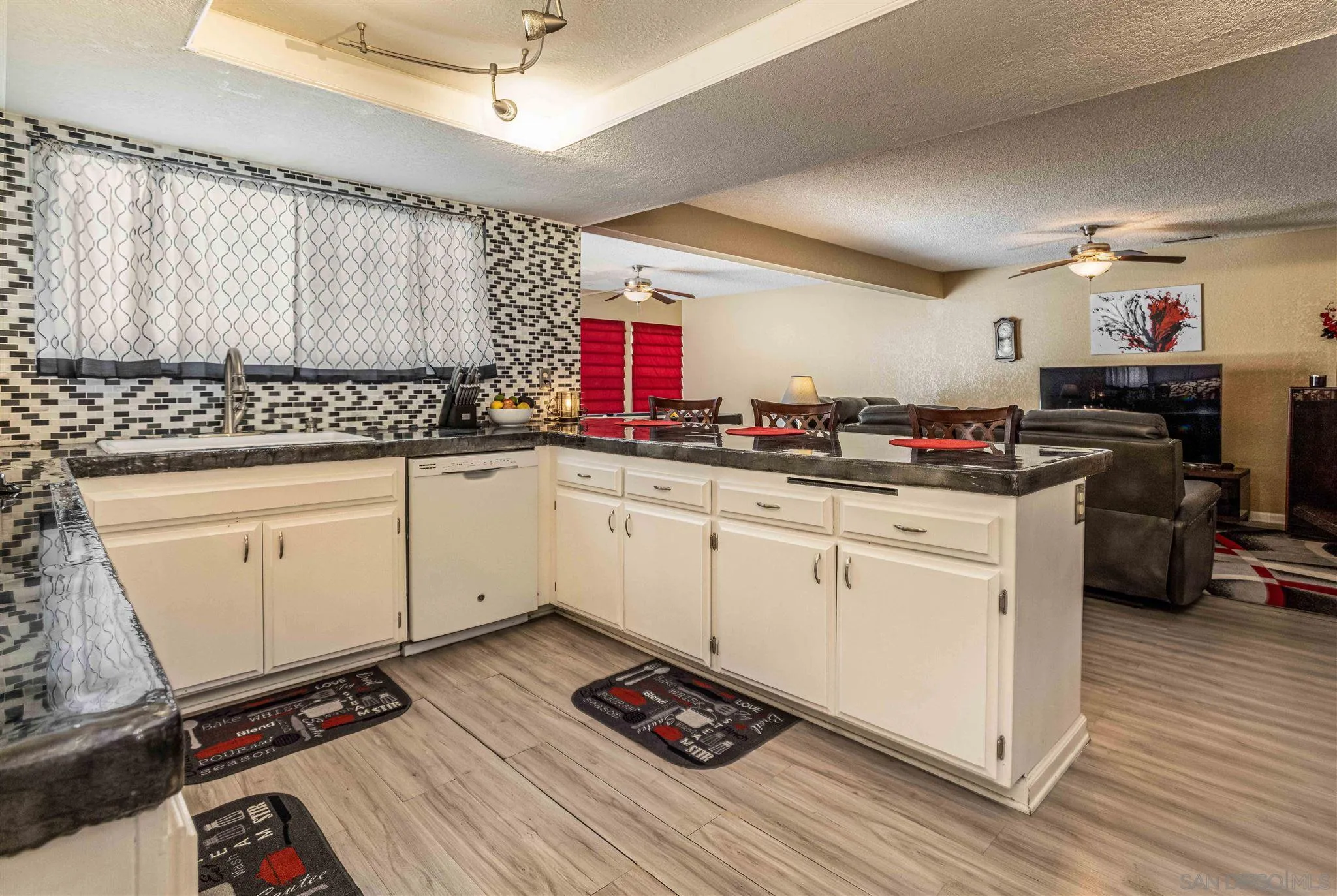 24392 Rutherford Road Ramona, CA 92065 - Photo 3 of 29 a kitchen with white cabinets and sink