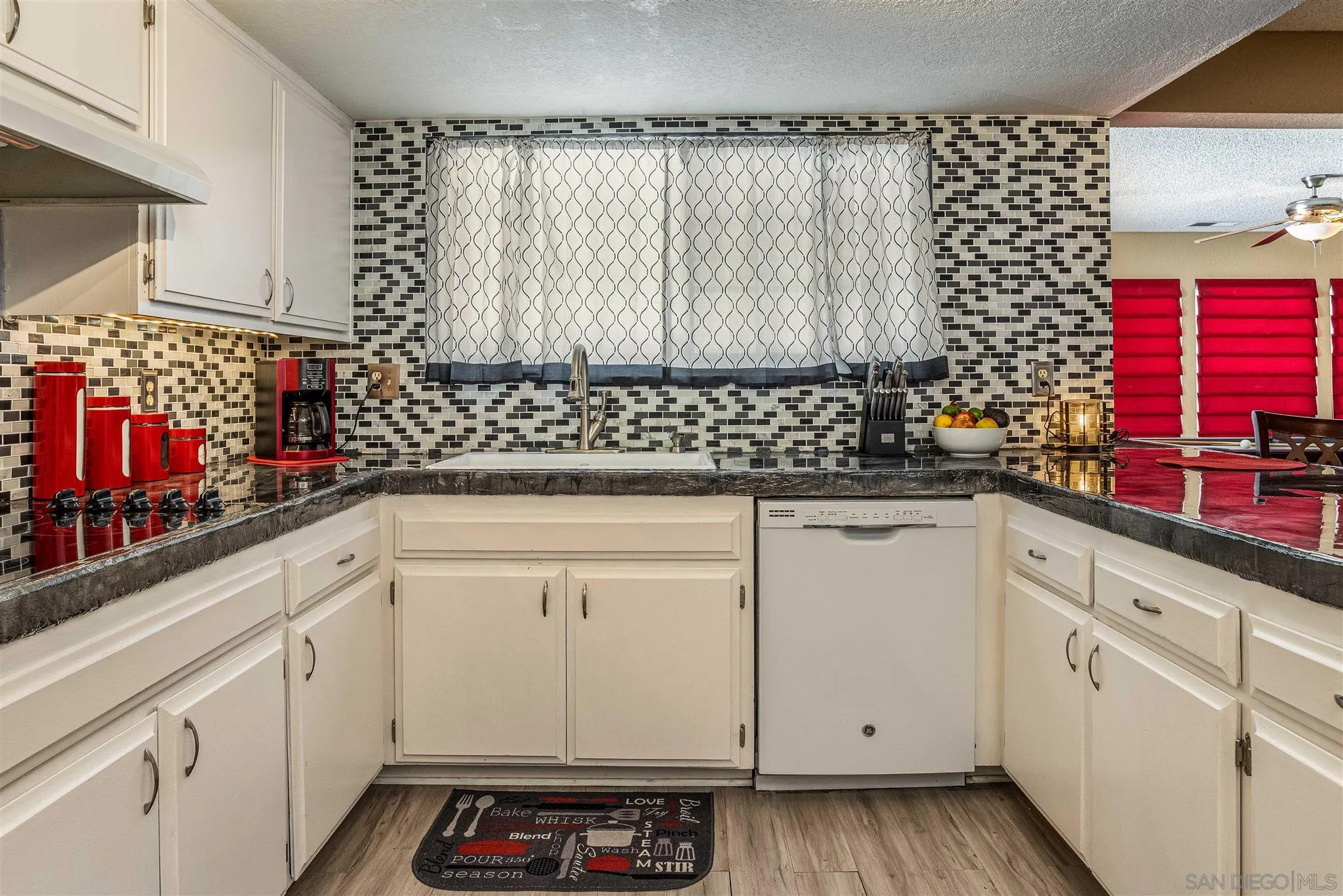 24392 Rutherford Road Ramona, CA 92065 - Photo 5 of 29 a kitchen with white cabinets and sink