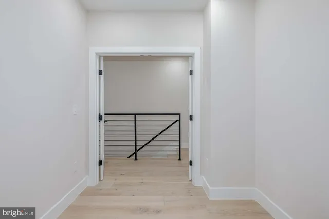 a view of a livingroom with wooden floor and glass door