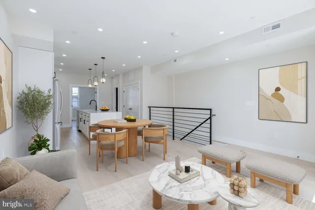 a dining room with furniture and wooden floor