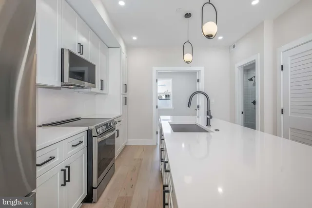 a kitchen with a sink stainless steel appliances and cabinets