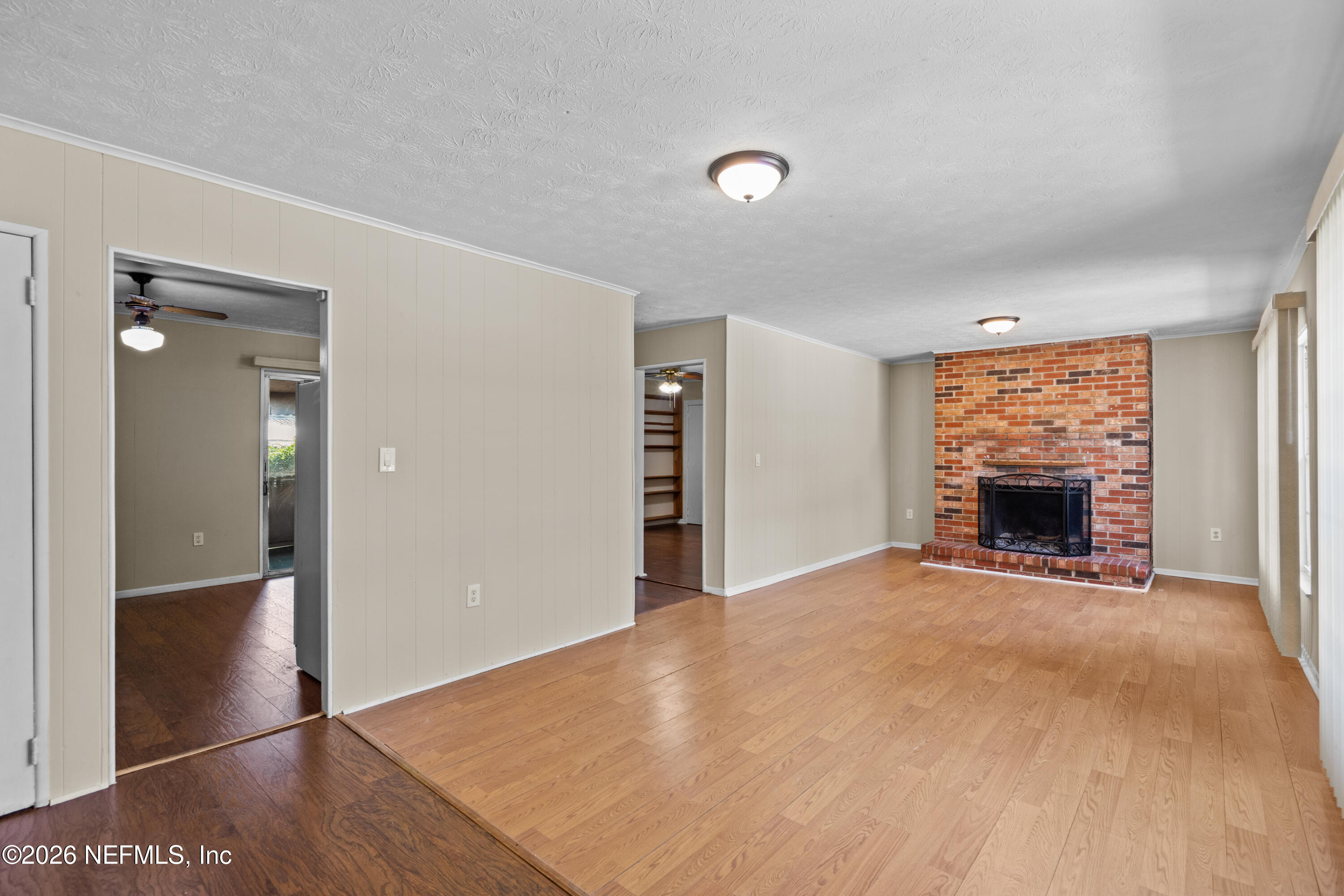 253 Cowry Road St. Augustine, FL 32086 - Photo 4 of 27 a view of an empty room with window and a fireplace