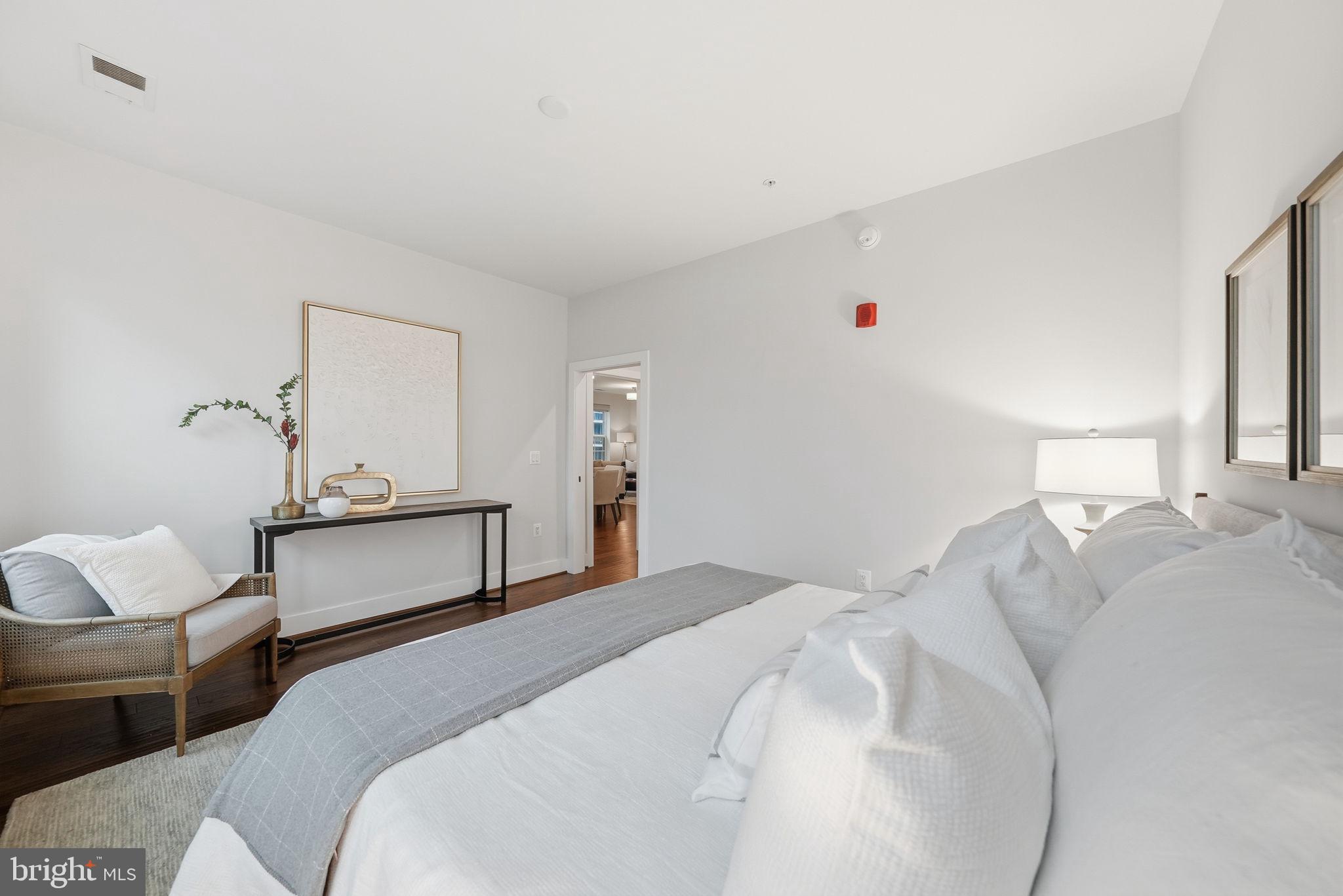 1411 Key Boulevard, Unit 505 Arlington, VA 22209 - Photo 11 of 26 a bedroom with bed and window