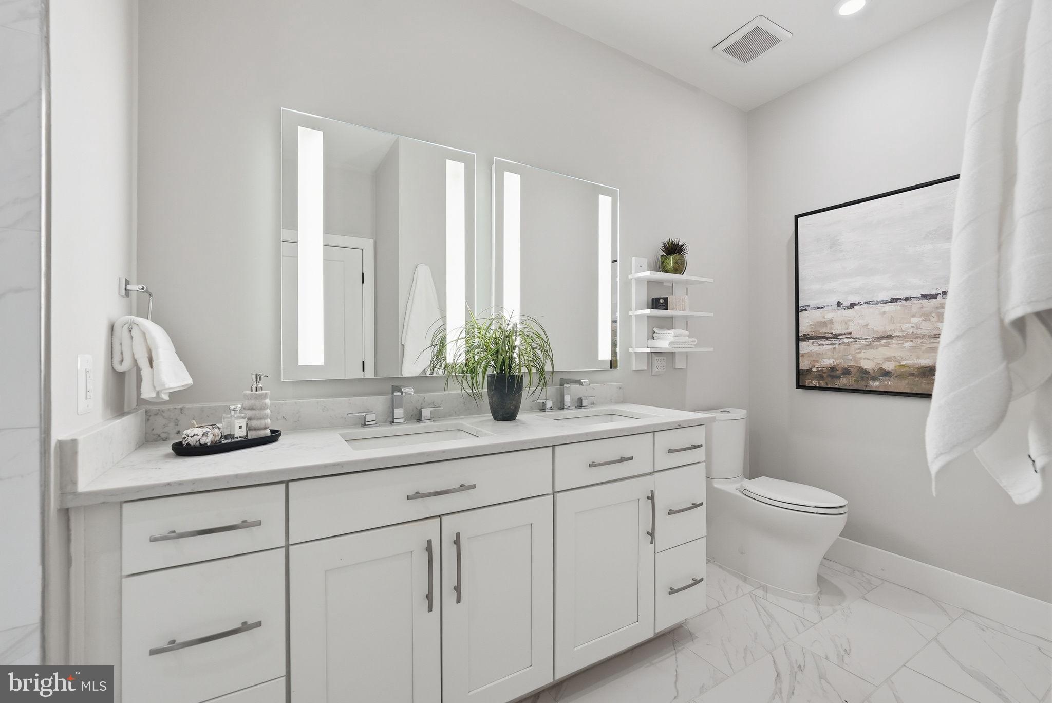 1411 Key Boulevard, Unit 505 Arlington, VA 22209 - Photo 13 of 26 a bathroom with a toilet sink and mirror
