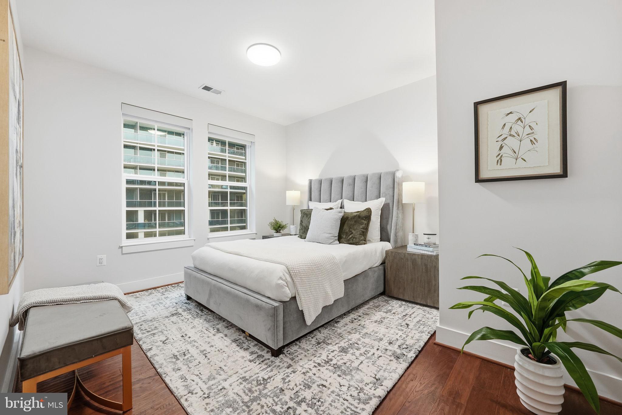 1411 Key Boulevard, Unit 505 Arlington, VA 22209 - Photo 16 of 26 a bedroom with a bed and wooden floor