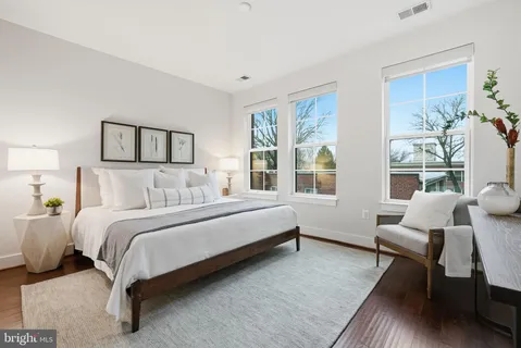 a spacious bedroom with a bed and a couch