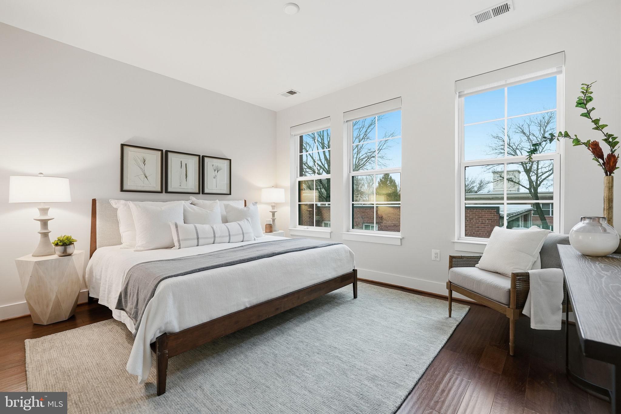 1411 Key Boulevard, Unit 505 Arlington, VA 22209 - Photo 10 of 26 a spacious bedroom with a bed and a couch