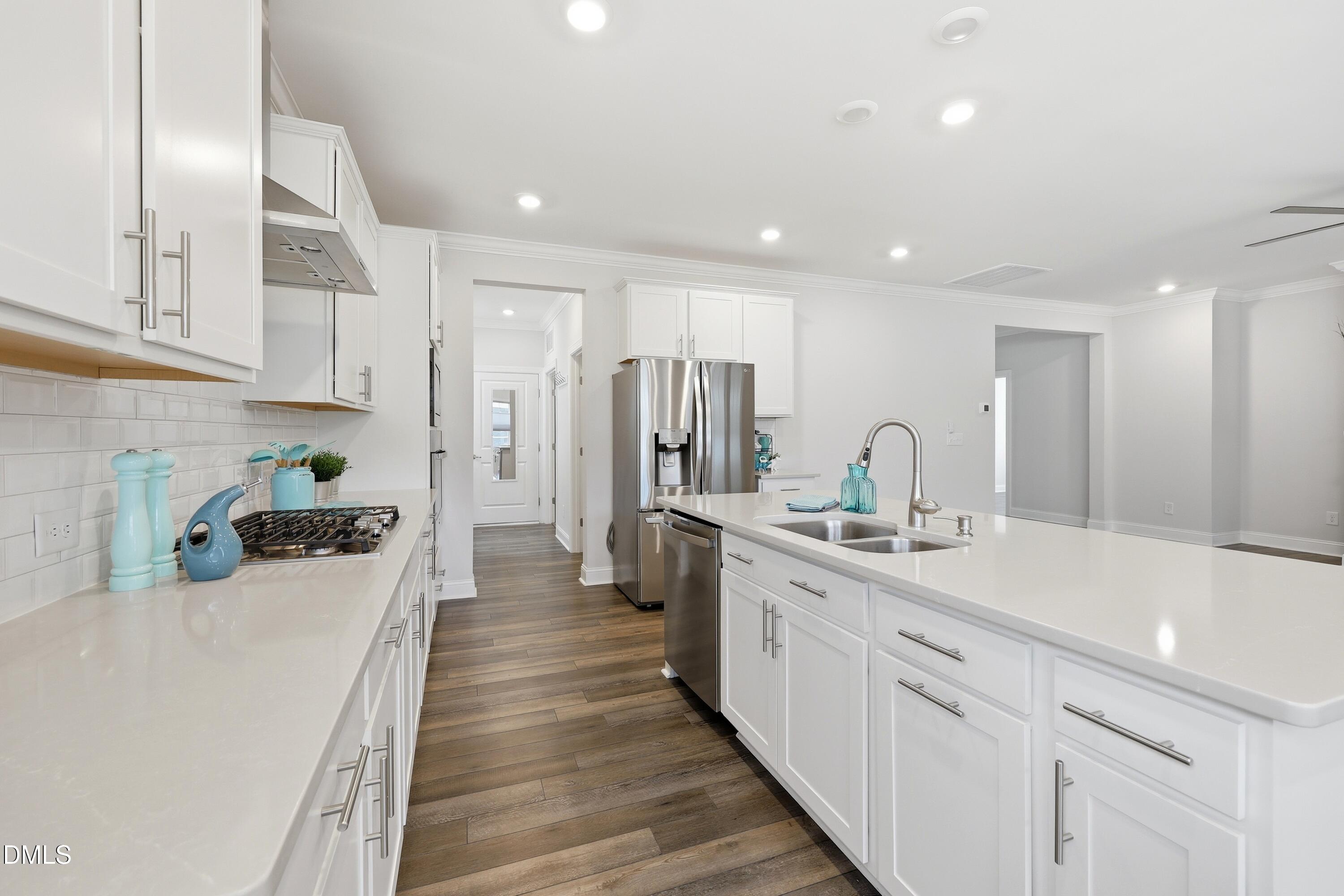 289 English Violet Lane Raleigh, NC 27610 - Photo 14 of 40 a kitchen with a sink stove and refrigerator