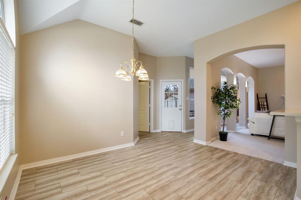 921 West Muirfield Road Garland, TX 75044 - Photo 13 of 33 a view of livingroom with hardwood floor and a ceiling fan