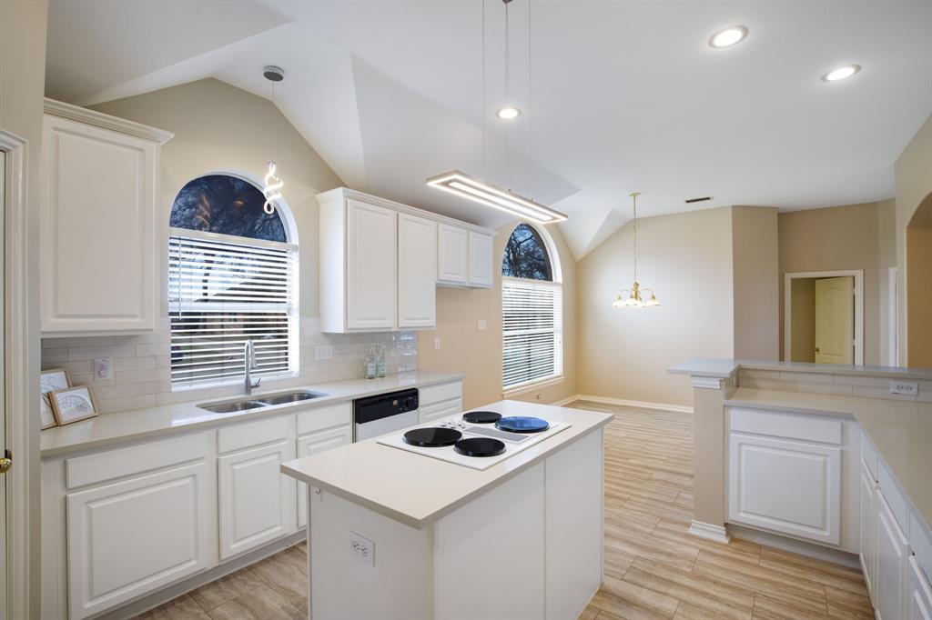 921 West Muirfield Road Garland, TX 75044 - Photo 17 of 33 a kitchen with a sink stove and cabinets