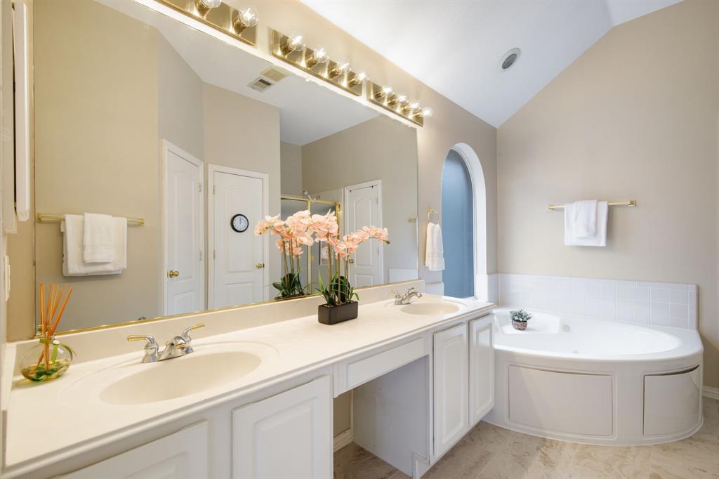 921 West Muirfield Road Garland, TX 75044 - Photo 23 of 33 a bathroom with a double vanity sink mirror and bathtub