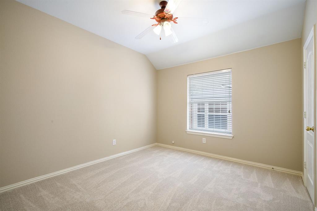 921 West Muirfield Road Garland, TX 75044 - Photo 27 of 33 an empty room with a window and a chandelier fan