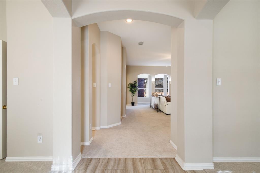 921 West Muirfield Road Garland, TX 75044 - Photo 3 of 33 a view of a hallway with wooden shelves