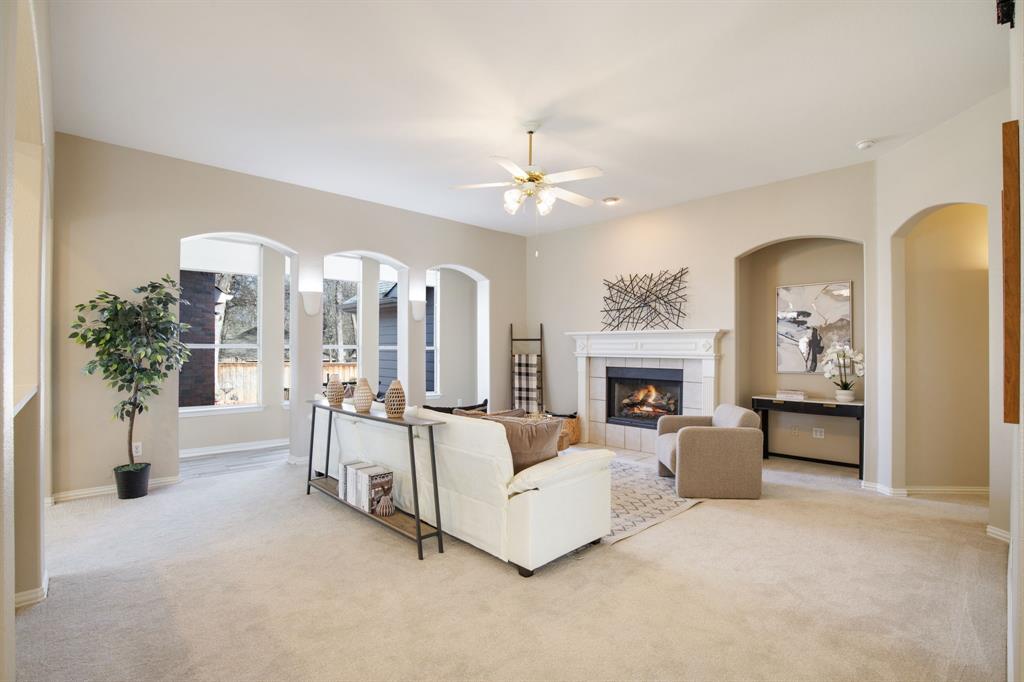 921 West Muirfield Road Garland, TX 75044 - Photo 6 of 33 a living room with furniture and a fireplace