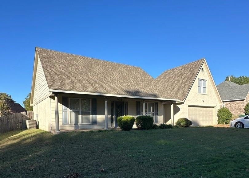 9420 Grove Road Cordova, TN 38016 - Photo 1 of 15 View of front of property with a front yard, a shingled roof, stucco siding, and an attached garage
