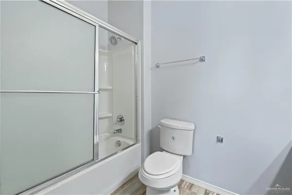 a bathroom with a granite countertop toilet and a shower