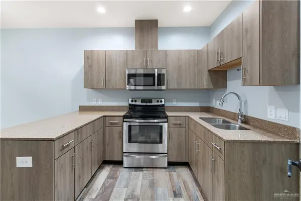 a kitchen with a sink stove and microwave