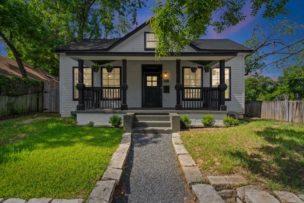1201 Garden Street, Unit A Austin, TX 78702 - Photo 27 of 30 Charming bungalow exterior featuring a covered front porch with dark wood columns and railings