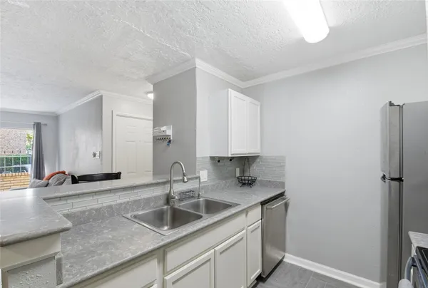 a kitchen with a sink and a refrigerator