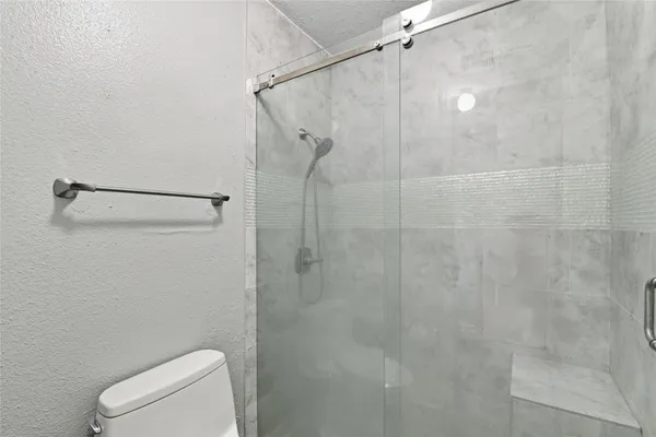 a bathroom with a shower and toilet
