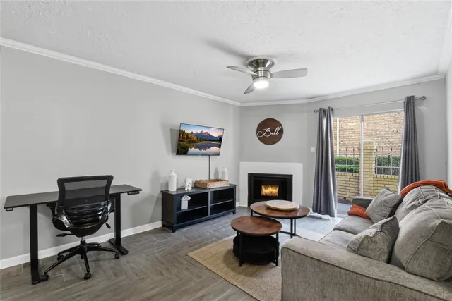 a living room with furniture a fireplace and a window