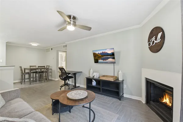 a living room with furniture a rug and a fireplace