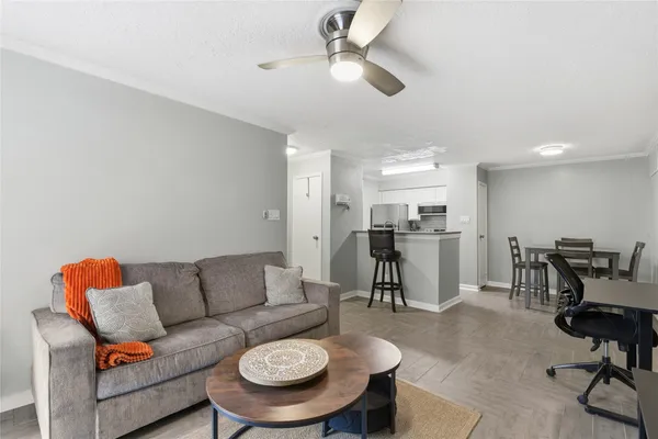 a living room with furniture kitchen view and a piano