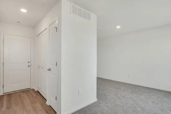 a view of hallway with wooden floor