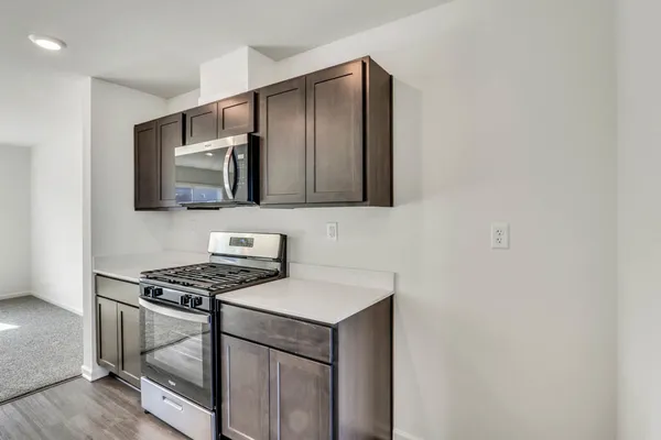 a kitchen with stainless steel appliances cabinets and a window