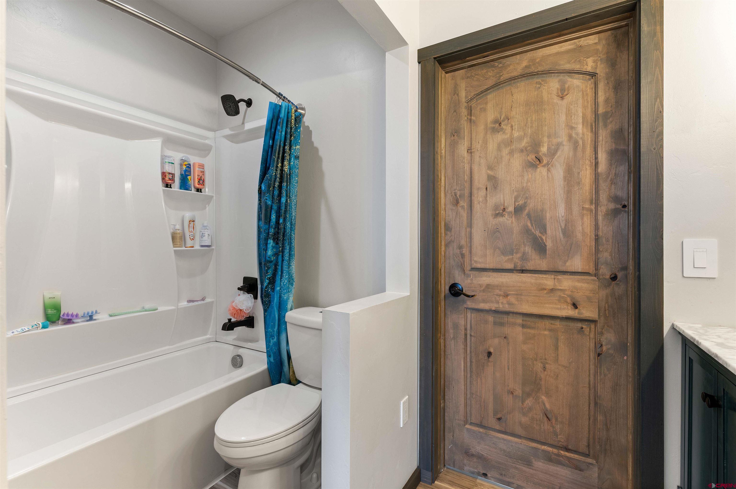 55347 Begonia Road Delta, CO 81416 - Photo 14 of 44 a bathroom with a toilet and a bathtub