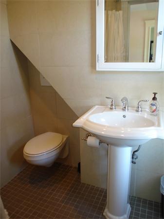 7 Loring Road Weston, MA 02493 - Photo 18 of 20 a bathroom with a sink a toilet and mirror