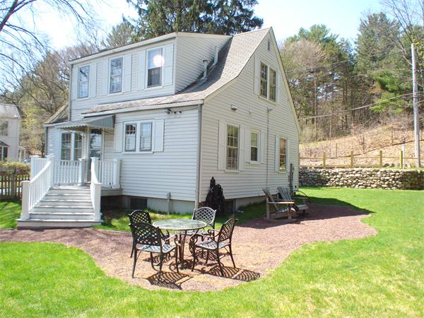 7 Loring Road Weston, MA 02493 - Photo 20 of 20 a view of a chair and table in backyard of the house