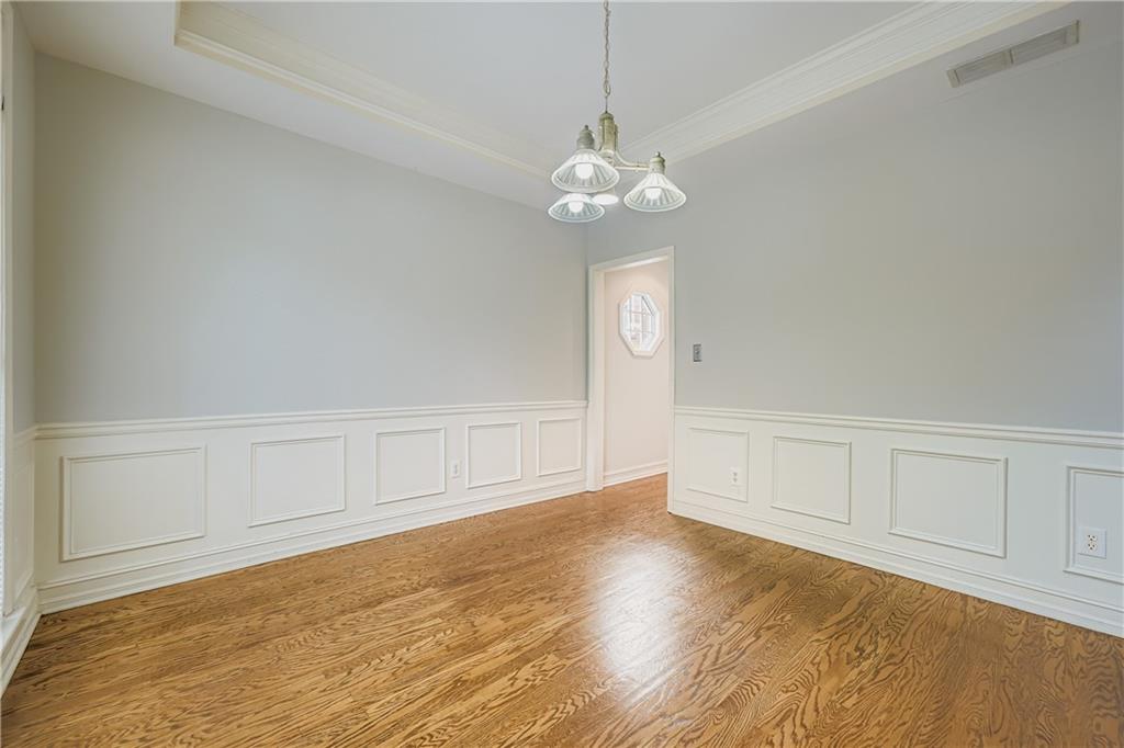1581 Oak Park Cove Decatur, GA 30033 - Photo 9 of 32 a view of an empty room with chandelier fan and wooden floor