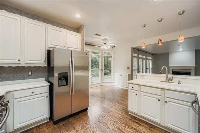 a kitchen with stainless steel appliances a refrigerator sink and cabinets
