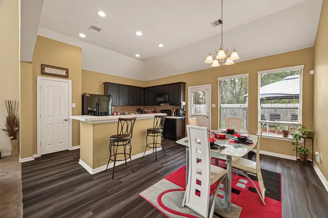 a very nice looking living room with furniture and a open to kitchen