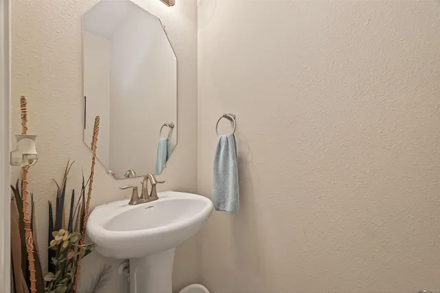 a bathroom with a sink and mirror