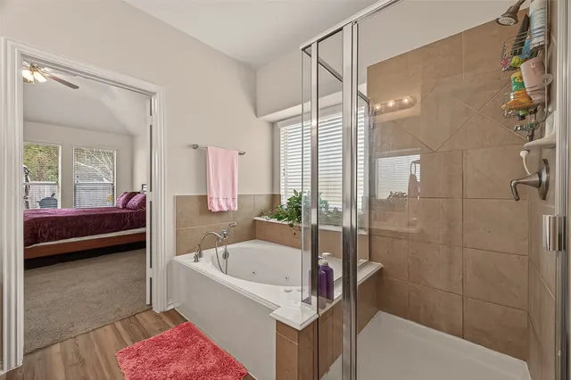 a bathroom with a tub a sink and a shower